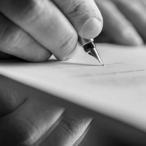 Hand writing with a pen on paper.
